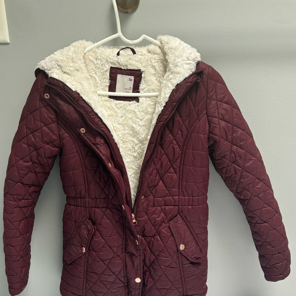 Dark red coat with pockets and white fur on the inside